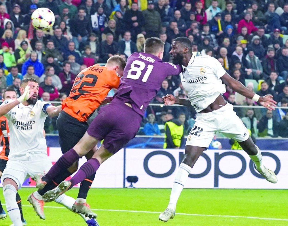 Real Madrid's German defender Antonio Rudiger (R) scores the 1-1 goal Shakhtar Donetsk's Ukrainian goalkeeper Anatoliy Trubin (2nd R) and Shakhtar Donetsk's Ukrainian defender Mykola Matviyenko (3rd R) try to stop the ball during the UEFA Champions League group F football match Shakhtar Donetsk vs Real Madrid in Warsaw, Poland, on October 11, 2022.  (Photo by JANEK SKARZYNSKI / AFP)

