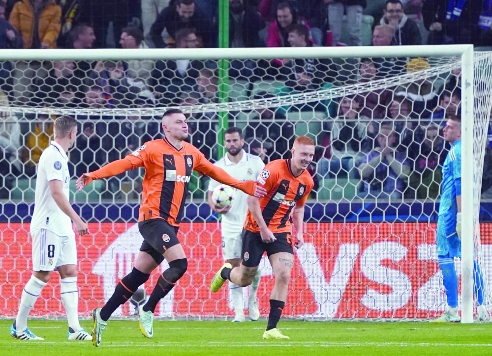 Shakhtar Donetsk's Ukrainian forward Oleksandr Zubkov (2nd L) celebrates after scoring the 1-0 goal during the UEFA Champions League group F football match Shakhtar Donetsk vs Real Madrid in Warsaw, Poland, on October 11, 2022.  (Photo by JANEK SKARZYNSKI / AFP)

