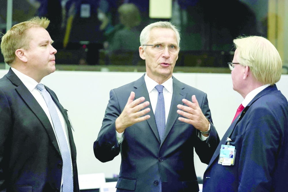 NATO Secretary General Jens Stoltenberg speaks with Finland's Minister of Defence Antti Kaikkonen (L) and Sweden's Defence Minister Peter Hultqvist as part of a Nato Defence Ministers Council at the Alliance headquarters in Brussels. -- AFP