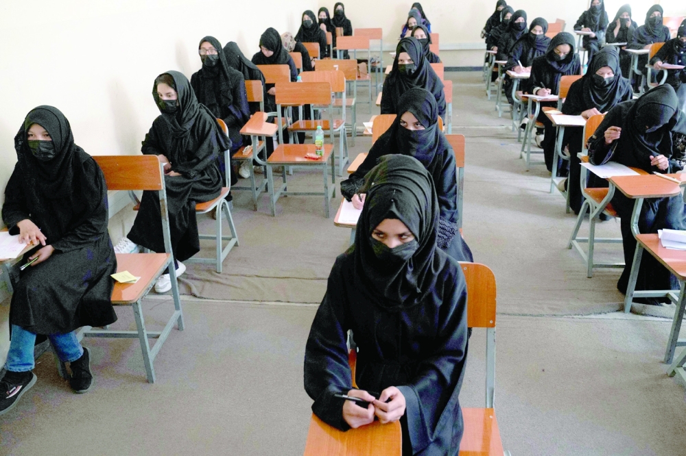 Afghan female students take entrance exams at Kabul University. -- AFP
