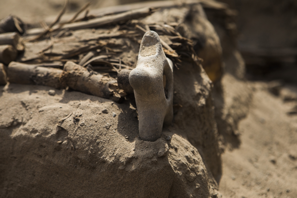 A stone mace found in a funerary bundle in an ancient tomb discovered beneath a street in a residential district north of Lima, Peru, Sept. 30, 2022. (Marco Garro/The New York Times)