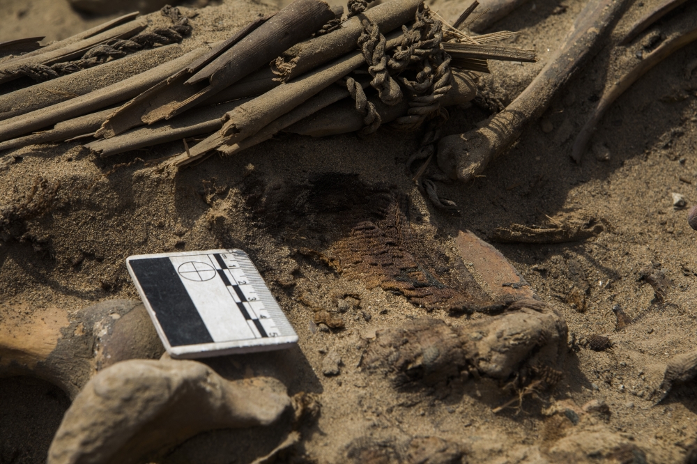 Textile fragments found in an ancient tomb discovered beneath a street in a residential district north of Lima, Peru, Sept. 30, 2022. (Marco Garro/The New York Times)