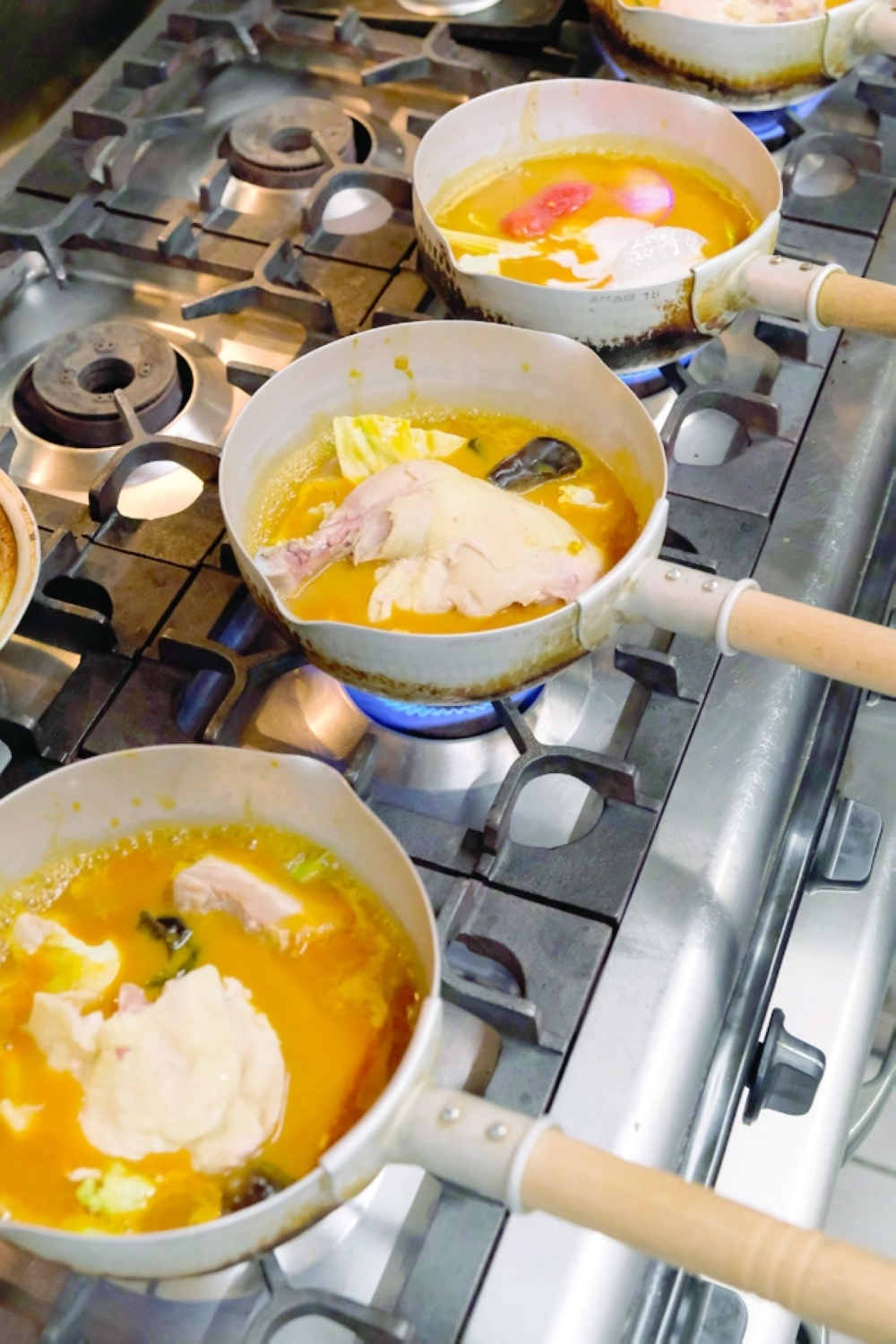 Soup curry on the burners at a location of Rojiura Curry Samurai in Kamakura, Japan. (Andrew Faulk/The New York Times)