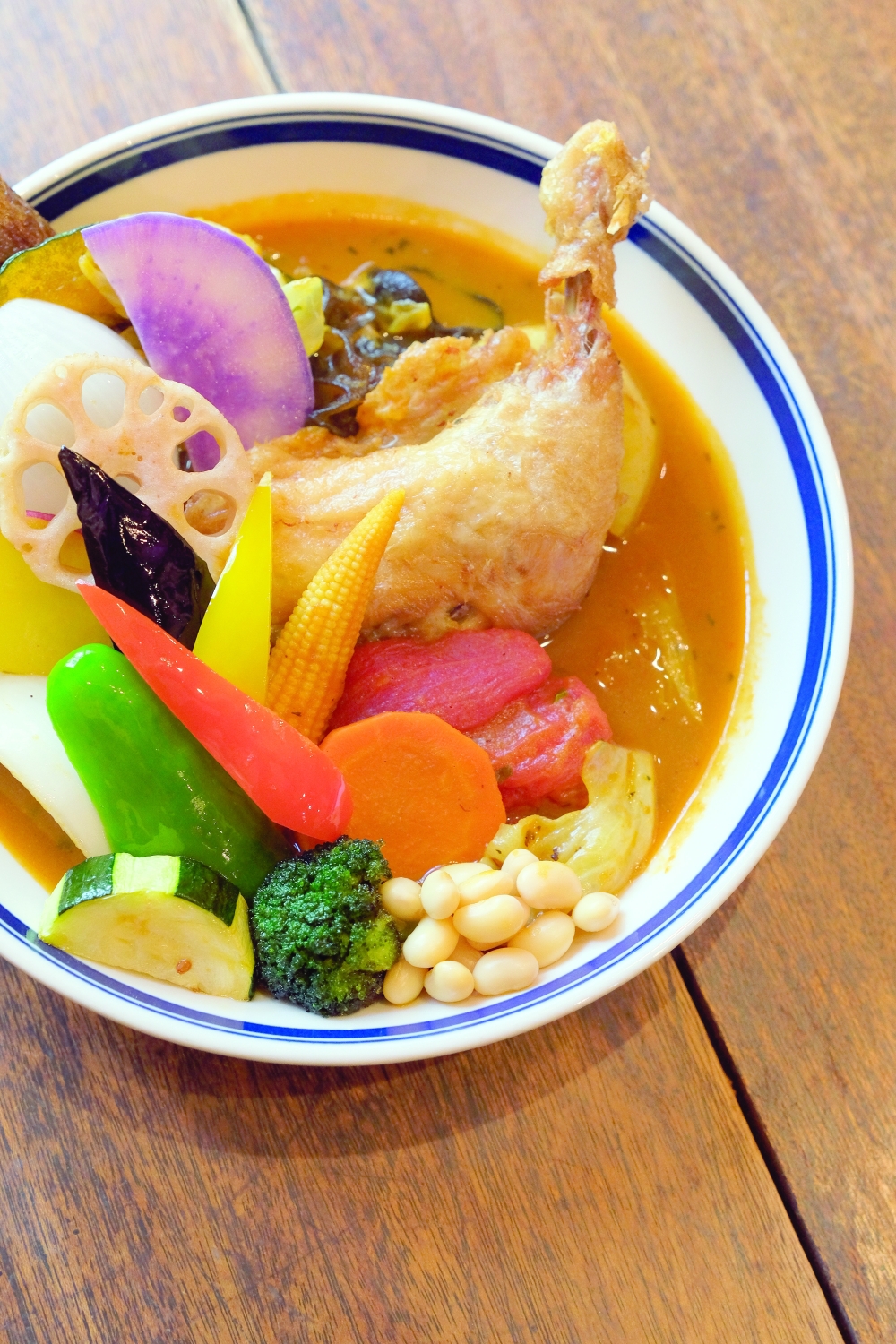 The signature soup curry with crispy chicken thigh and 13 vegetables at a location of Rojiura Curry Samurai in Kamakura, Japan. (Andrew Faulk/The New York Times)