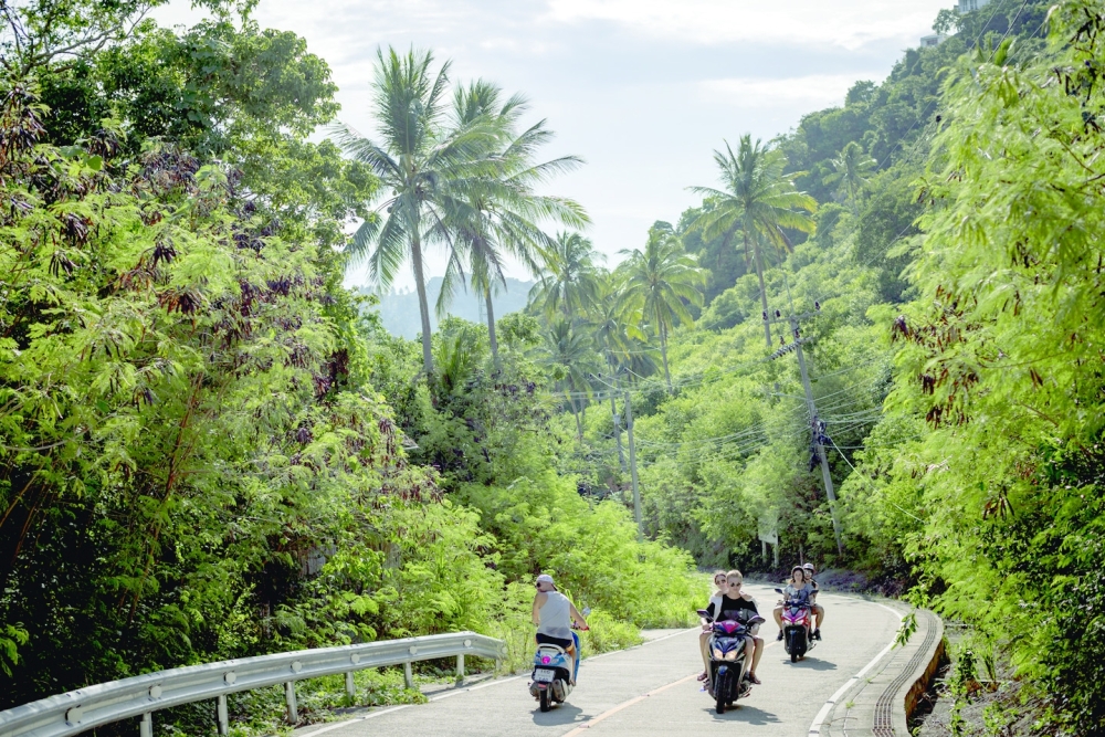 Tourists in motorbikes in Koh Tao, Thailand, on Sept. 5, 2022. (Jack Taylor/The New York Times)