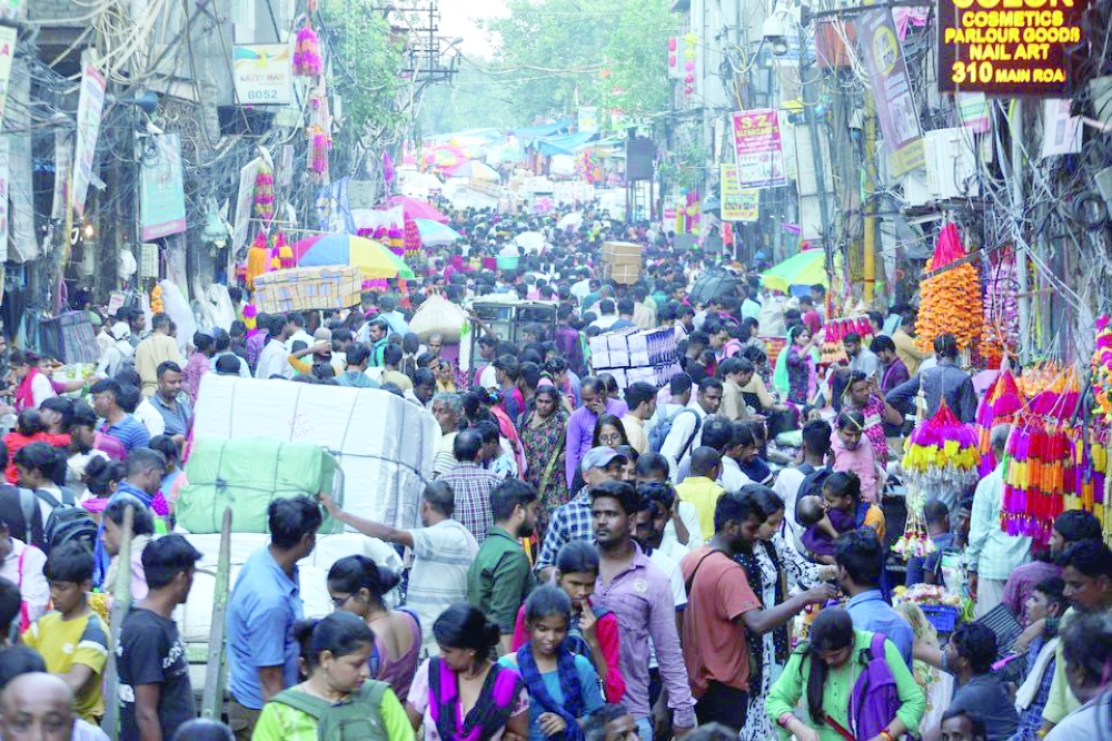 People shop at a crowded market ahead of Diwali in the old quarters of Delhi. -- Reuters