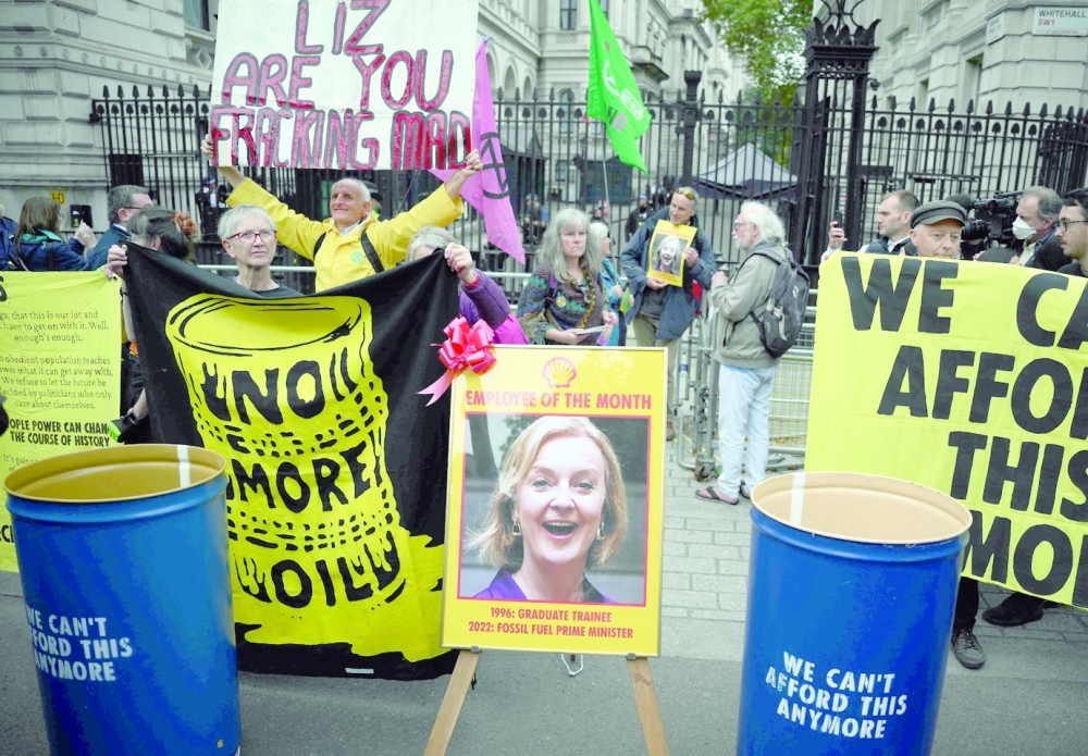 Protesters gather outside the gates of Downing Street during a demonstration by the climate change protest group Extinction Rebellion. Truss has said that Greenpeace and Extinction Rebellion were part of an 'anti-growth coalition'. -- AFP