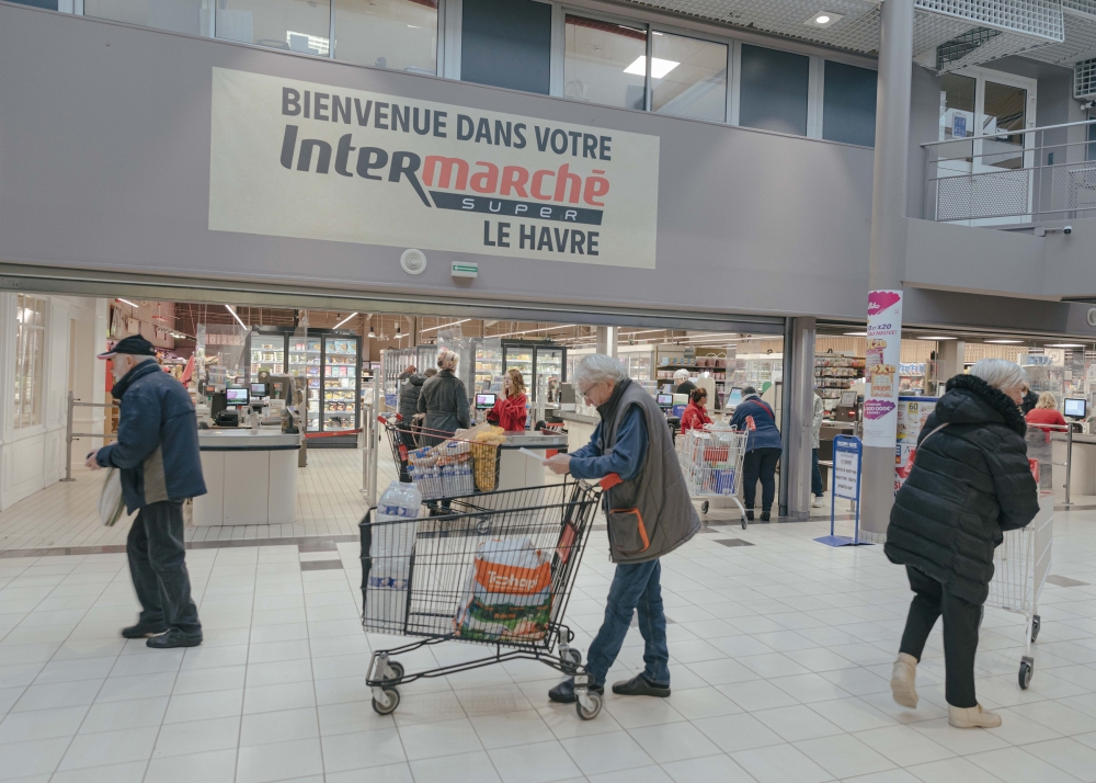 A customer looks at a receipt after making purchases at a supermarket in Le Havre, France, Oct. 13, 2022. (Andrea Mantovani/The New York Times)