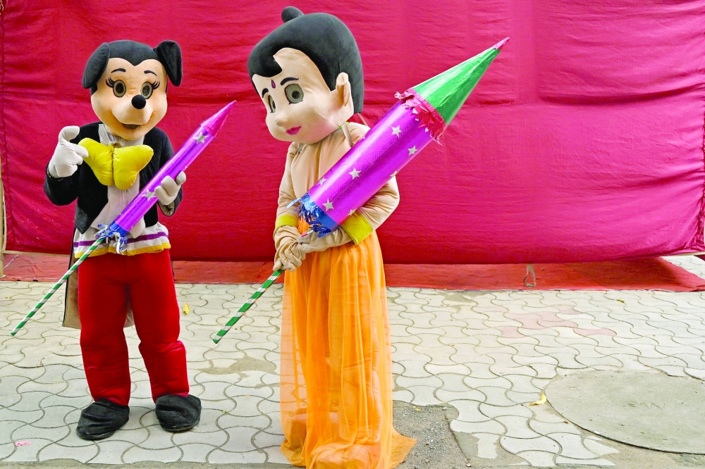 Firefighters dressed as cartoon characters take part in an awareness campaign against the use of firecrackers during the celebrations to mark the festival of Diwali, at a school in Chennai, India, on Thursday. - AFP