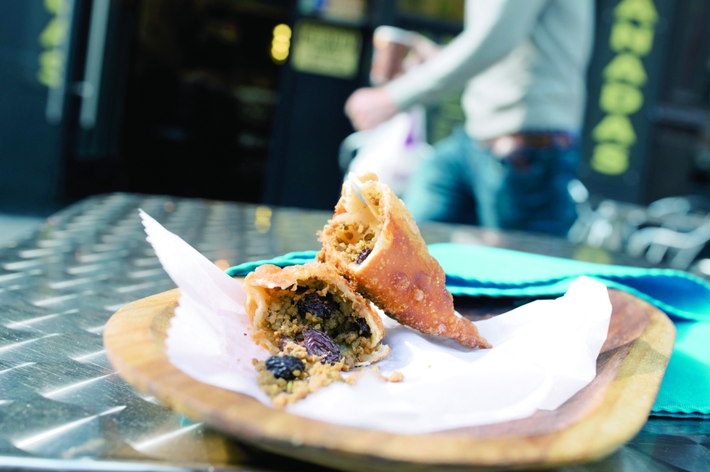 An empanada filled with ground beef and raisins at  KC Gourmet Empanadas in New York on Sept. 28, 2022. (José A. Alvarado Jr./The New York Times)