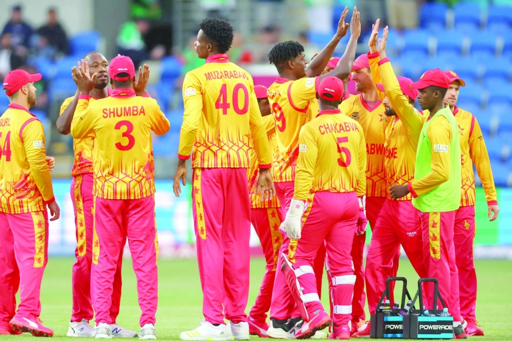 Zimbabwe's players celebrate the dismissal of Scotland's Michael Jones during the ICC men's Twenty20 World Cup 2022 cricket match between Scotland and Zimbabwe at Bellerive Oval in Hobart on October 21, 2022. (Photo by DAVID GRAY / AFP)

