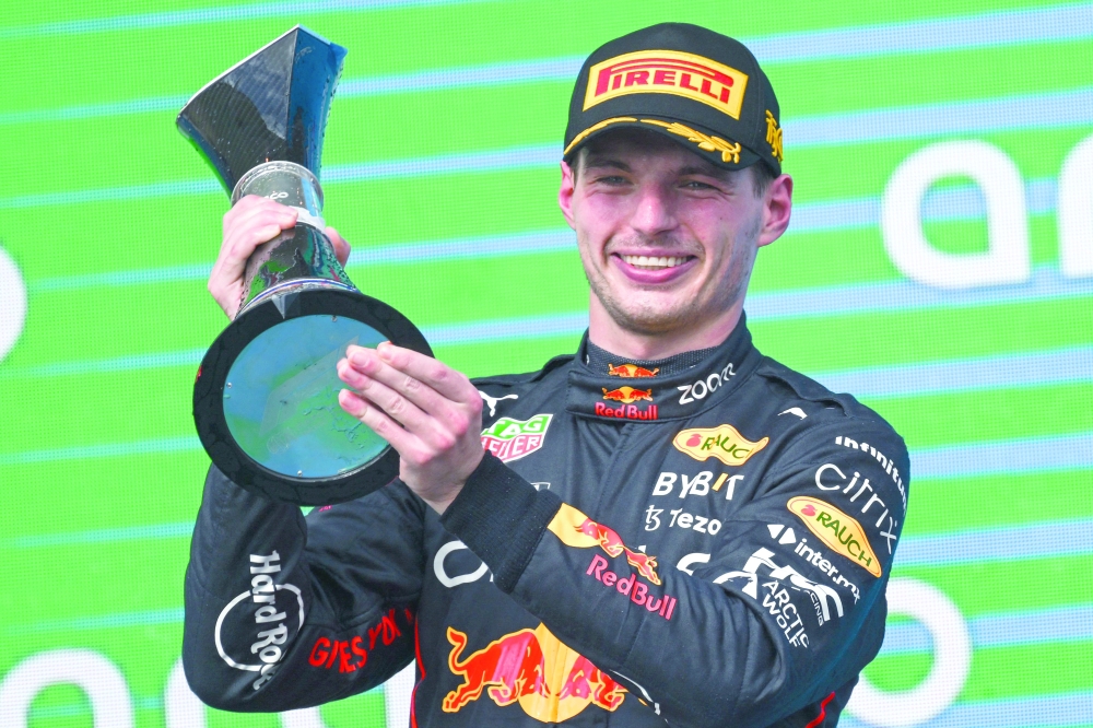 TOPSHOT - Red Bull Racing's Dutch driver Max Verstappen celebrates on the podium after winning the Formula One United States Grand Prix, at the Circuit of the Americas in Austin, Texas, on October 23, 2022. (Photo by Patrick T. FALLON / AFP)