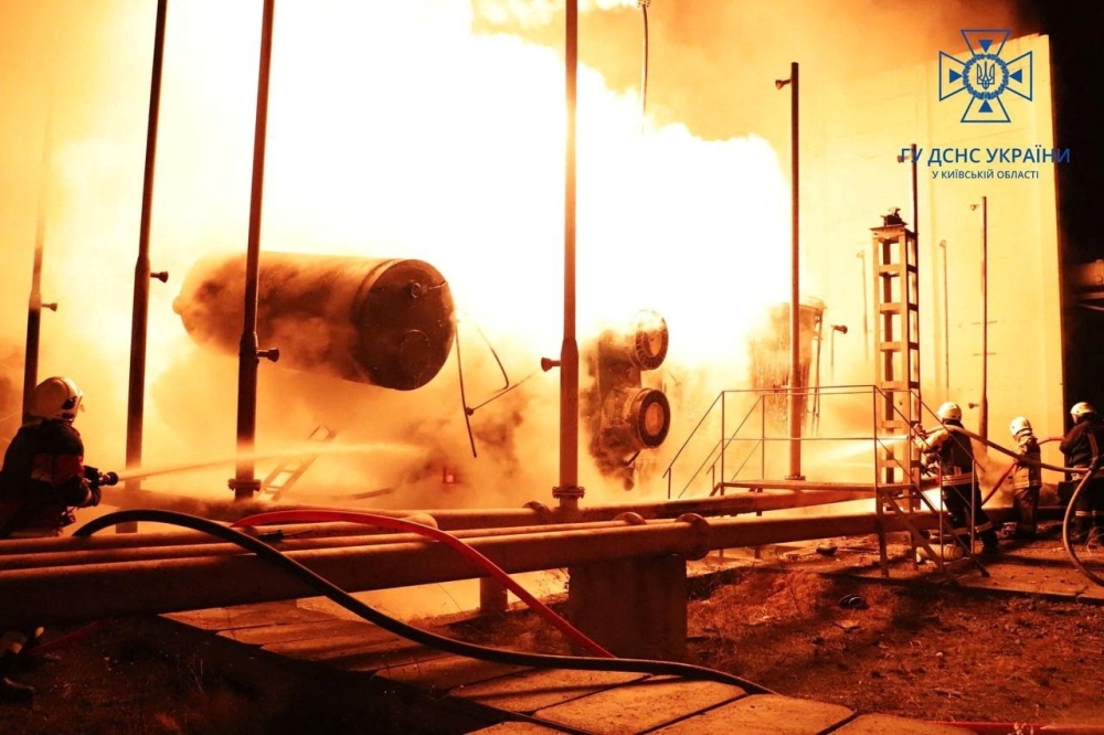 Firefighters work to put out a fire at energy infrastructure facilities, damaged by Russian drone strike, as Russia's attack on Ukraine continues, in undisclosed location, Ukraine October 27, 2022.