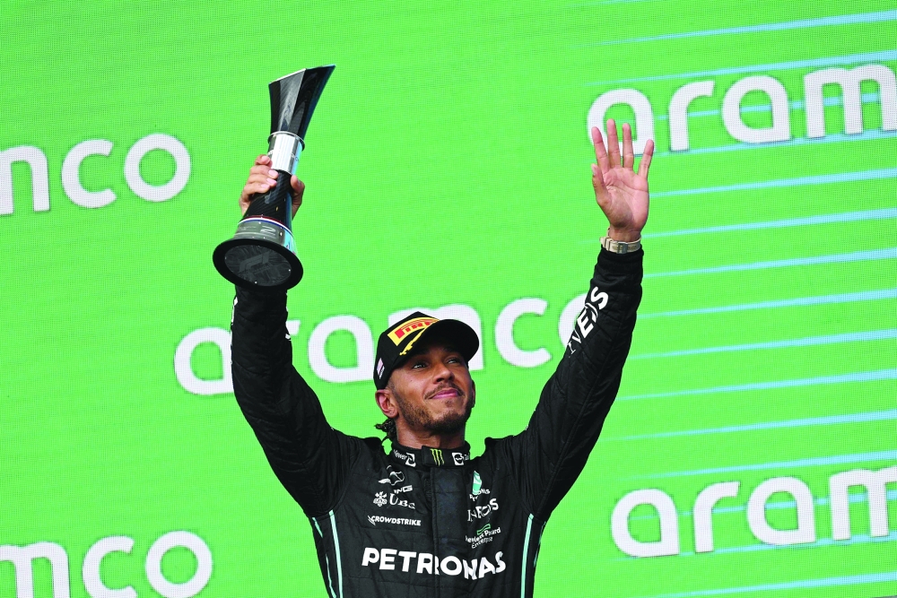 Mercedes' British driver Lewis Hamilton celebrates on the podium after placing second in the Formula One United States Grand Prix, at the Circuit of the Americas in Austin, Texas, on October 23, 2022. (Photo by Patrick T. FALLON / AFP)

