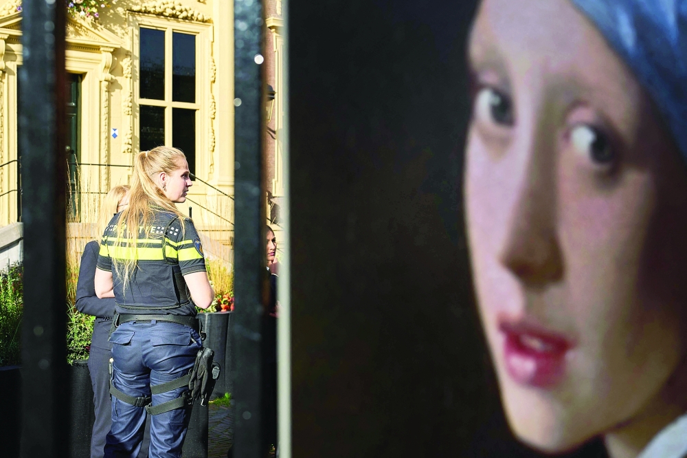 A policewoman stands guard outside the Mauritshuis museum after an attempt to smear the Johannes Vermeer's painting 'Girl with a Pearl Earring' in The Hague.  -- AFP