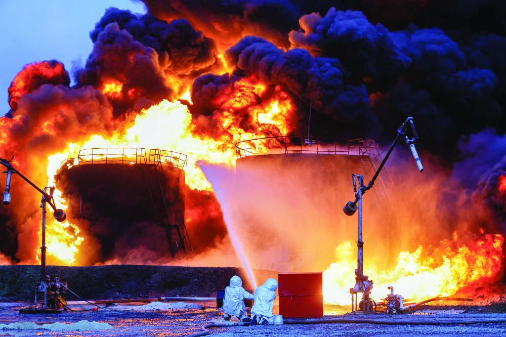 Firefighters work to extinguish fire following recent shelling at an oil storage in the town of Shakhtarsk near Donetsk, Russian-controlled Ukraine, on Thursday. -- Reuters

