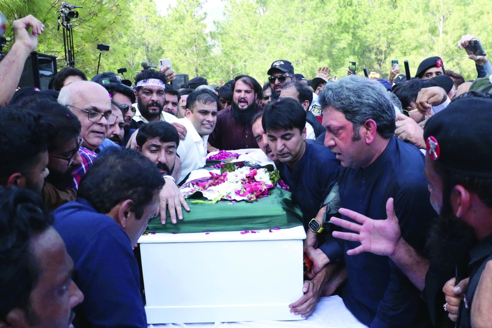 Mourners gather around the coffin of Pakistani journalist Arshad Sharif during his funeral ceremony at the Faisal mosque in Islamabad on Thursday. - AFP
