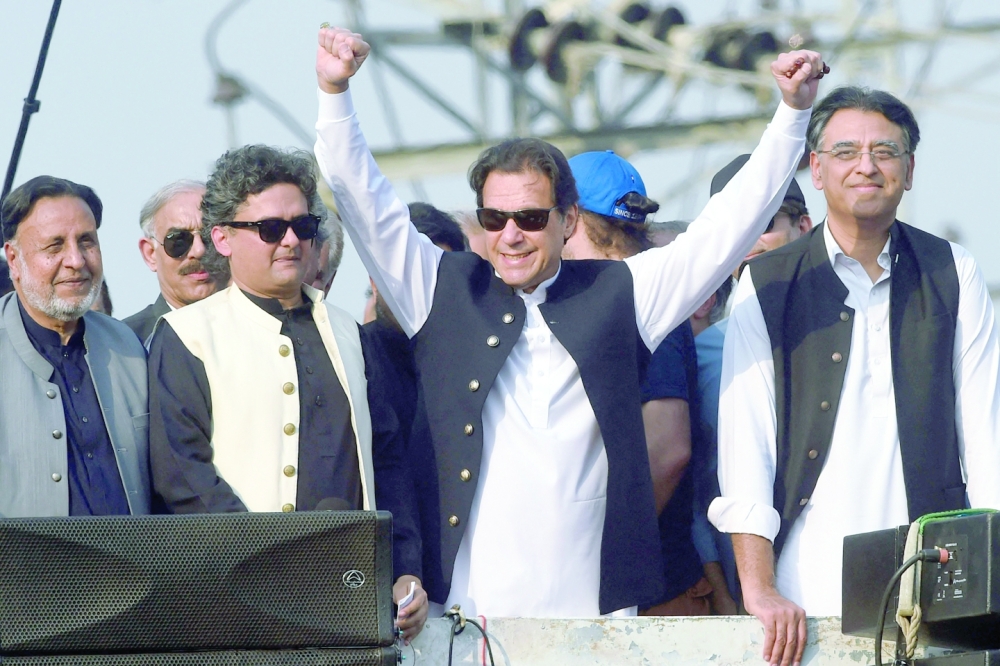 Former Pakistan prime minister Imran Khan gestures during an anti-government long march towards Islamabad to demand early elections. -- AFP