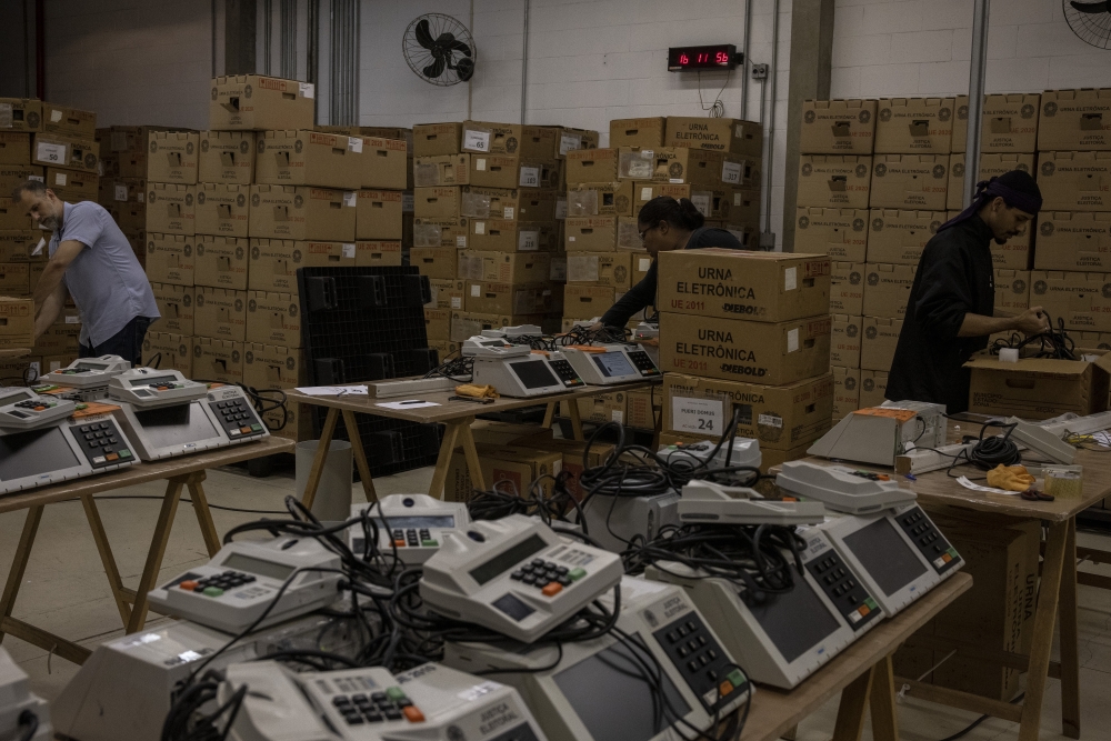 Brazilian court inspectors audit and seal electronic voting machines.