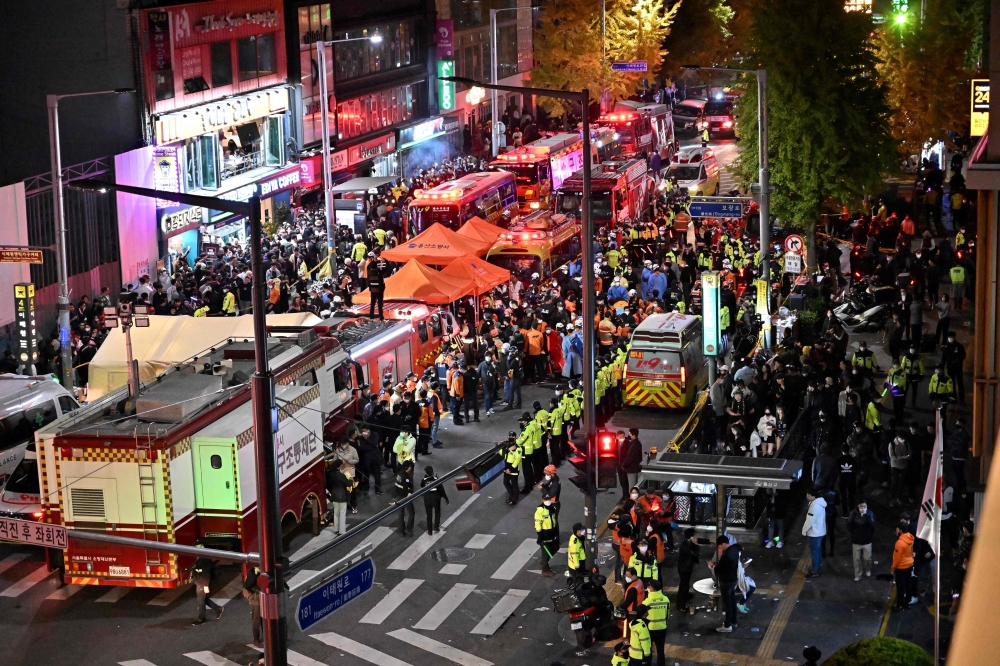 Crowds are seen around the area, where dozens of people suffered cardiac arrest, in the popular nightlife district of Itaewon in Seoul on October 30, 2022.
