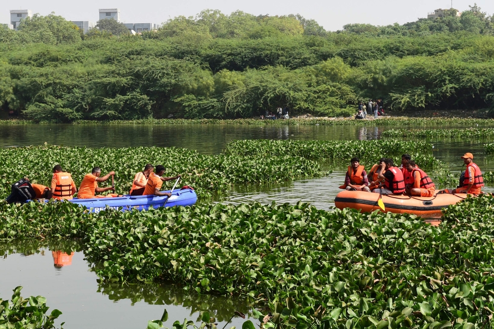 Rescue personnel conduct search operations after a bridge across the river Machchhu collapsed at Morbi in India's Gujarat state on October 31, 2022.