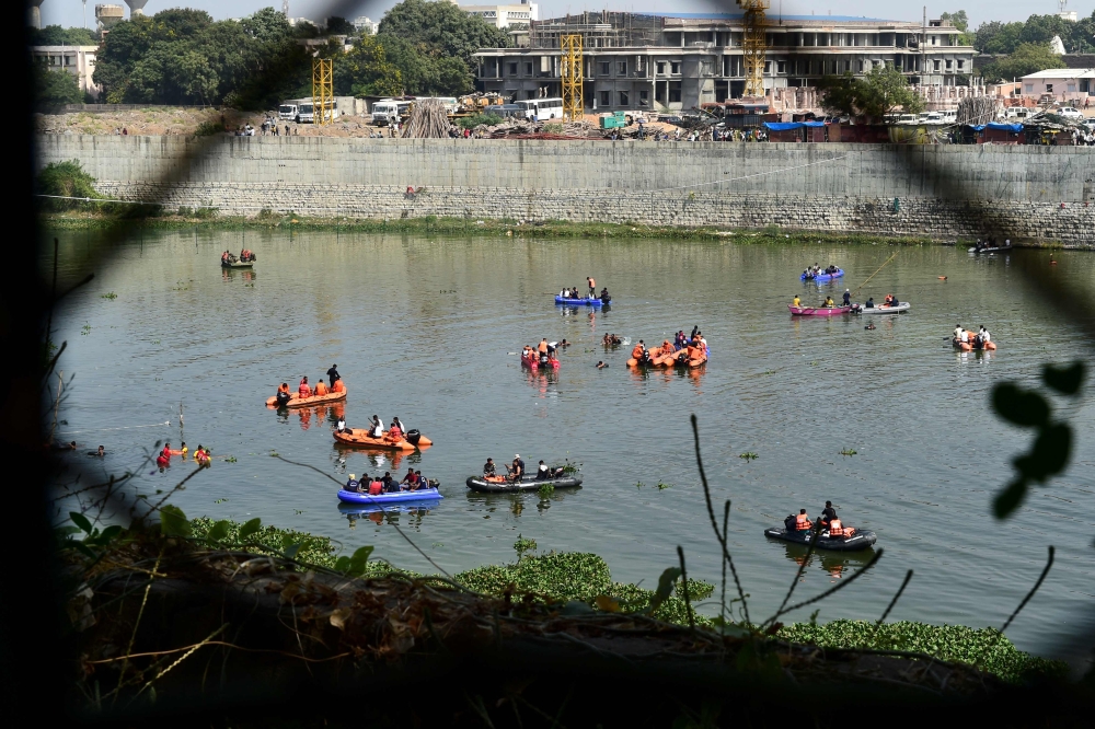 Rescue personnel conduct search operations after a bridge across the river Machchhu collapsed at Morbi in India's Gujarat state on October 31, 2022.
