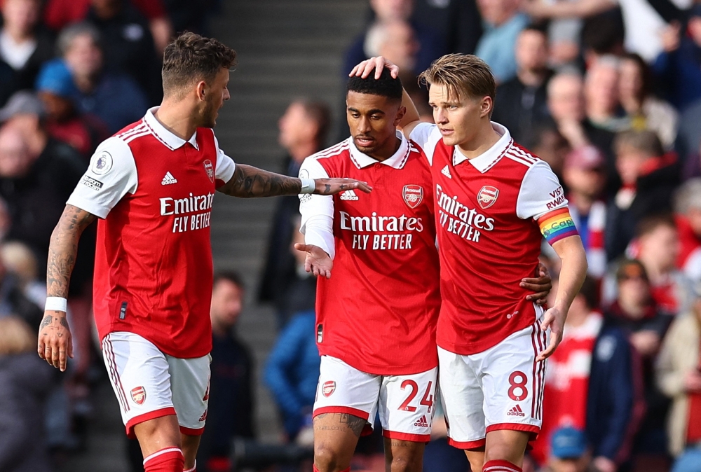 Arsenal's Reiss Nelson celebrates scoring their second goal with Arsenal's Ben White and Martin Odegaard. REUTERS/