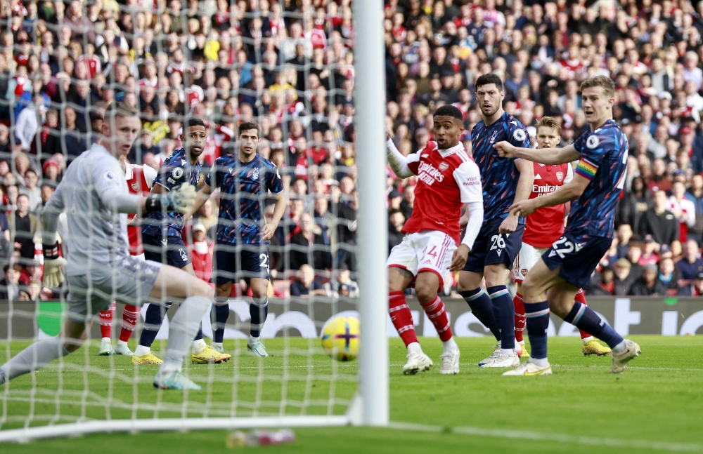 Arsenal's Reiss Nelson scores their third goal against Nottingham Forest. -- Reuters