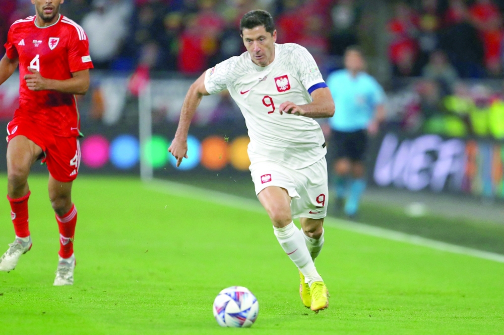 (FILES) In this file photo taken on September 25, 2022 Poland's striker Robert Lewandowski runs with the ball during the UEFA Nations League, league A group 4 football match between Wales and Poland at Cardiff City stadium in Cardiff, south Wales.  (Photo by Geoff Caddick / AFP)

