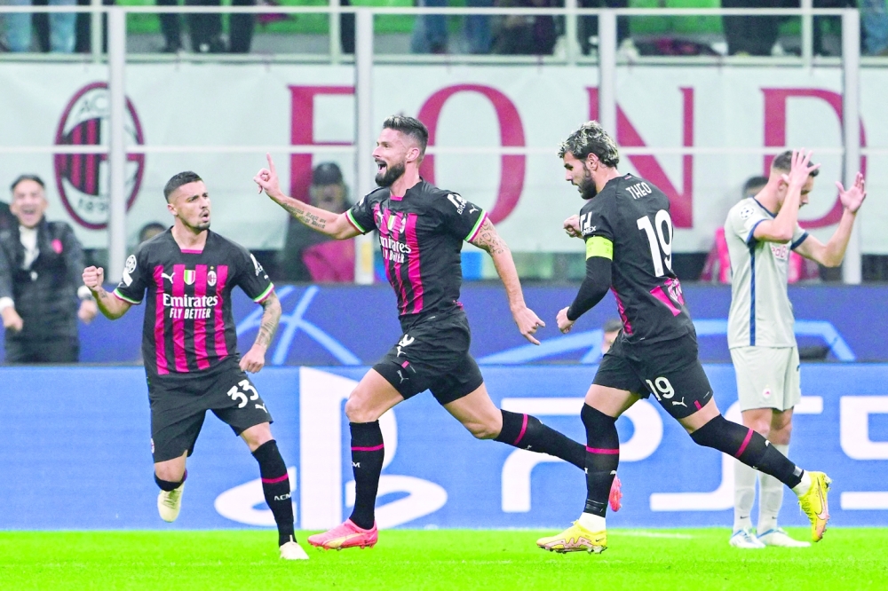 AC Milan's French forward Olivier Giroud (2ndL) celebrates after opening the scoring during the UEFA Champions League Group E football match between AC Milan and RB Salzburg on November 2, 2022 at the San Siro stadium in Milan. (Photo by MIGUEL MEDINA / AFP)

