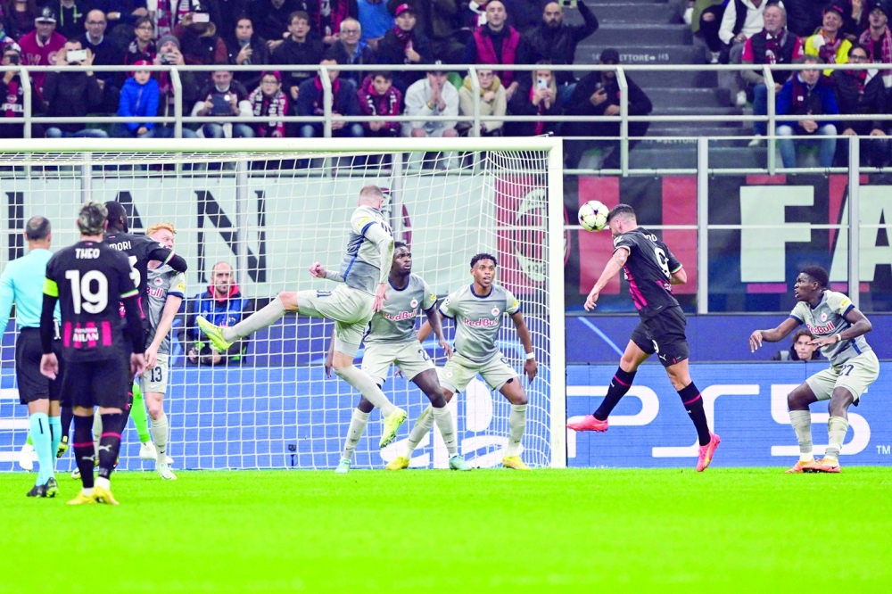 AC Milan's French forward Olivier Giroud (2ndR) scores a header during the UEFA Champions League Group E football match between AC Milan and RB Salzburg on November 2, 2022 at the San Siro stadium in Milan. (Photo by MIGUEL MEDINA / AFP)

