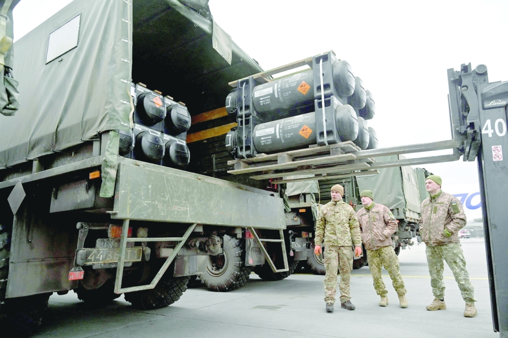Ukrainian servicemen load a truck with US-supplied Javelin anti-tank missiles. -- AFP