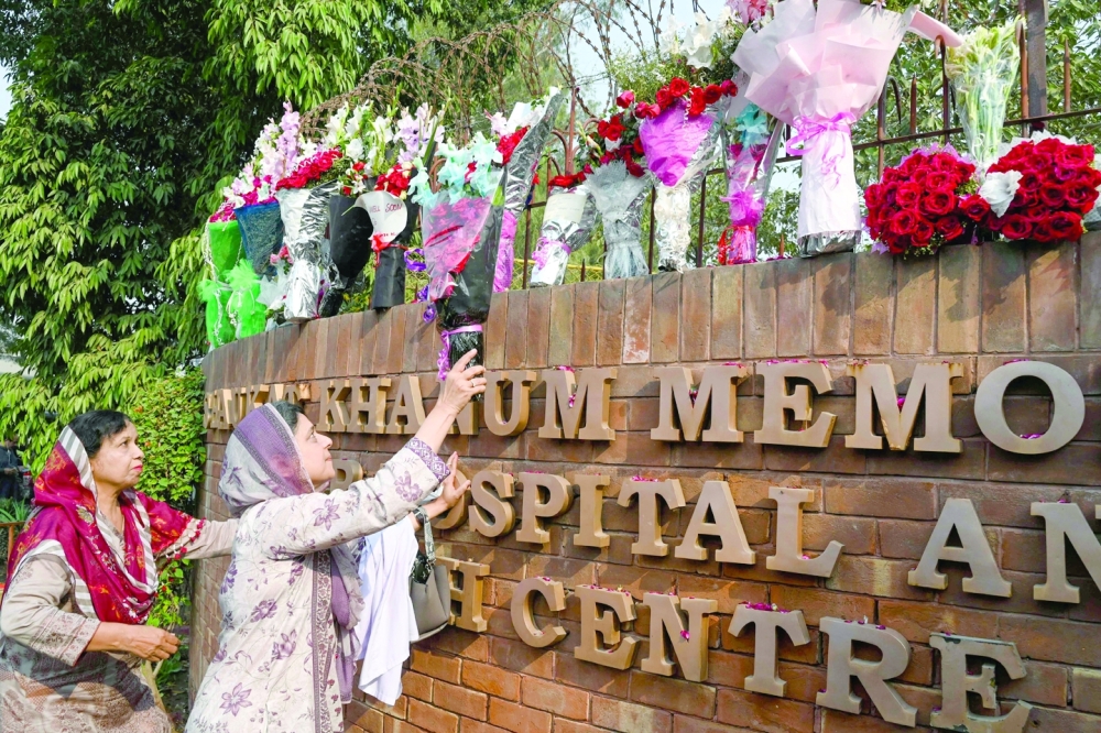 Supporters of Imran Khan place flowers outside the hospital in Lahore where Khan is admitted. -- AFP