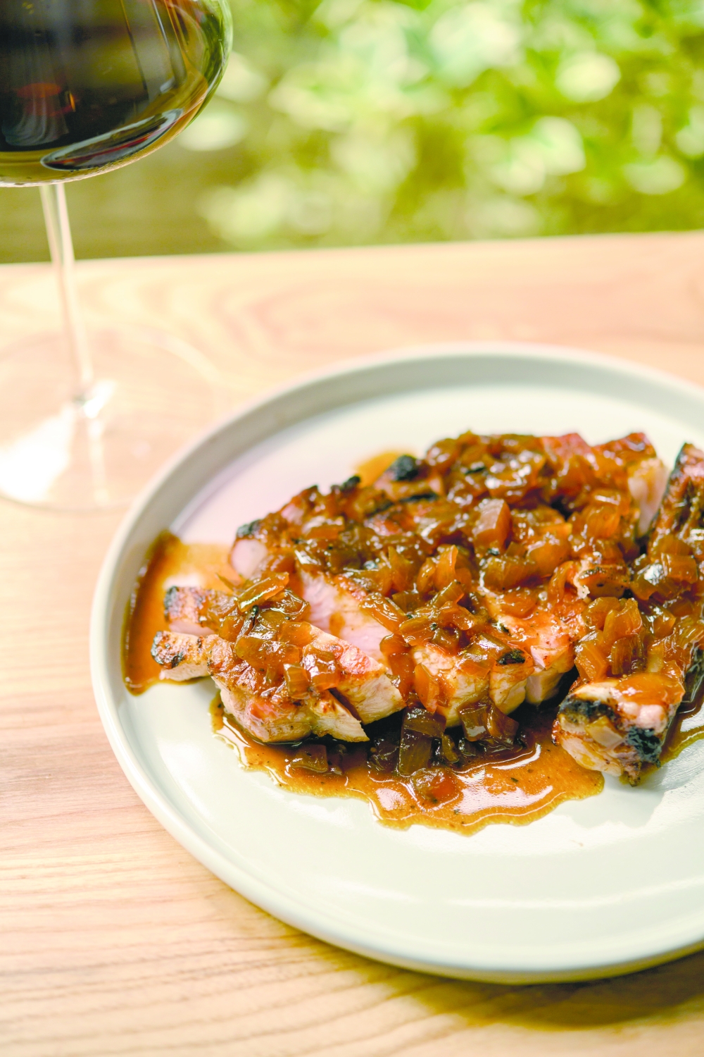 A pork chop served with smoked-onion jus at Claud in New York, Oct. 27, 2022. (Daniel Krieger/The New York Times)