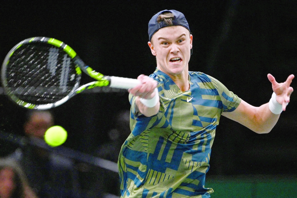 Denmark's Holger Rune plays a forehand return during the men's singles semi-final tennis match between Denmark's Holger Rune and Canada's Felix Auger-Aliassime on day 6 of the ATP World Tour Masters 1000 - Paris Masters (Paris Bercy) - indoor tennis tournament at The AccorHotels Arena in Paris on November 5, 2022.  (Photo by Christophe ARCHAMBAULT / AFP)

