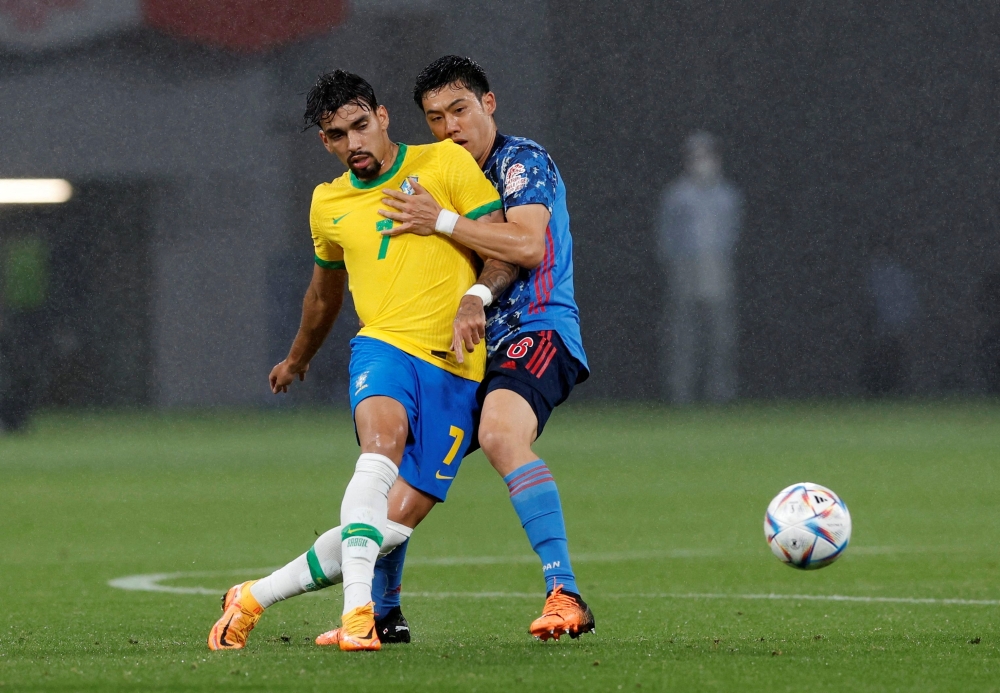 FILE PHOTO: Lucas Paqueta in action with Japan's Wataru Endo 