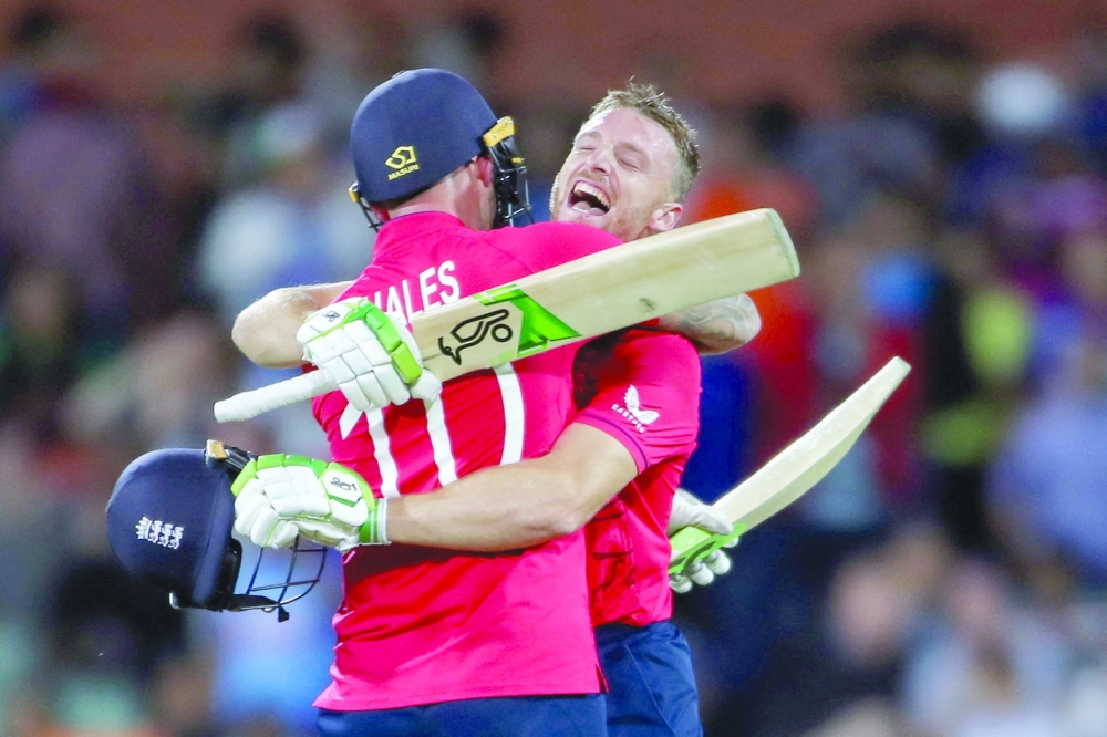 England's Jos Buttler and Alex Hales celebrate after winning the match  Dave Hunt/AAP Image via REUTERS     