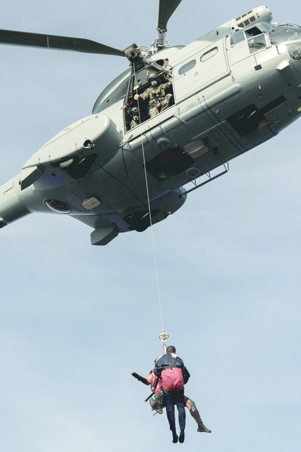 A migrant in need of urgent medical care is winched up by a helicopter of the French Army from the Ocean Viking rescue ship in the Tyrrhenian Sea between Italy and Corsica island on Thursday.  -- AFP