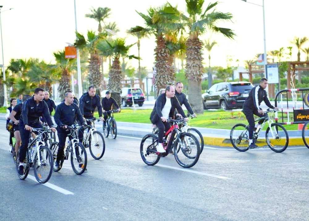 Egyptian President Abdel Fattah el Sisi rides a bicycle as he takes a tour of the Green Zone during the COP27 climate summit in Sharm el Sheikh on Thursday.