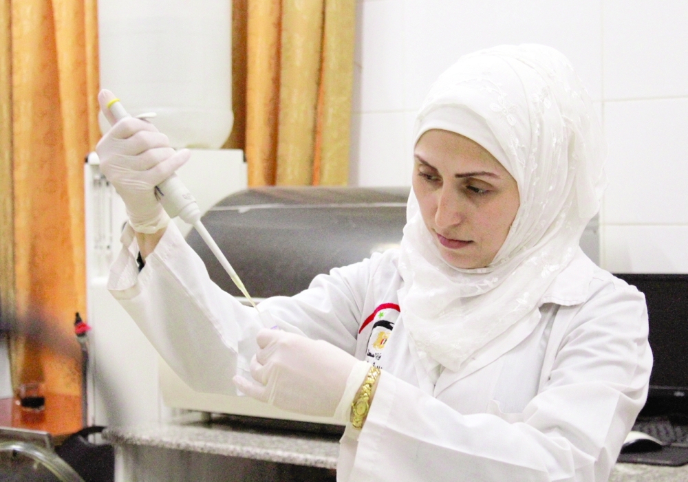 A medical practitioner works at a laboratory inside Ibn al Nafis hospital in Damascus. The Syrian health ministry had recorded 46 deaths as a result of delays in accessing medical care. -- Reuters