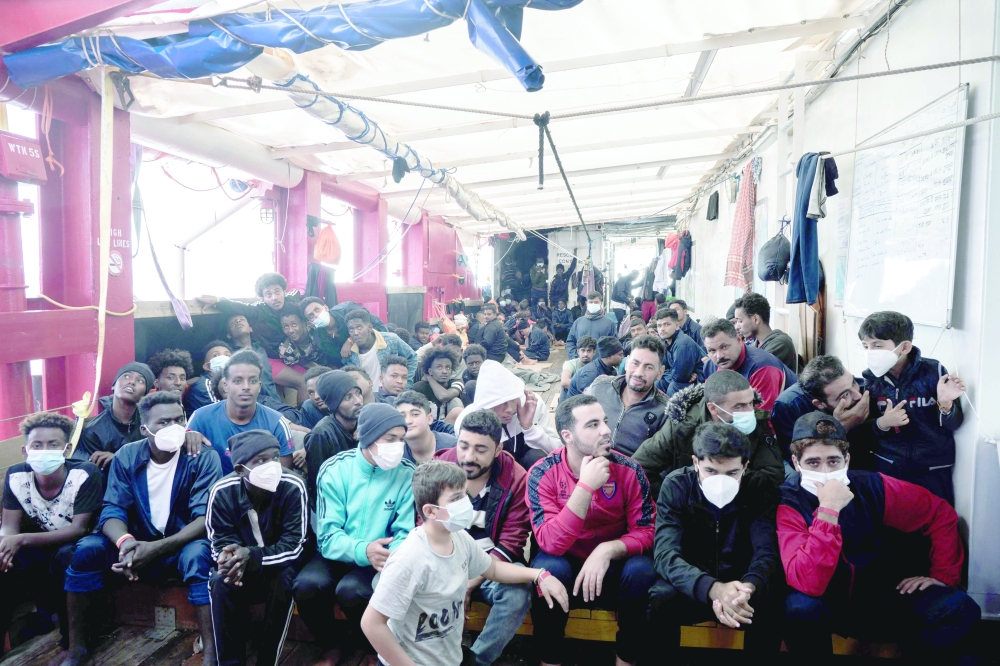 Migrants on board 'Ocean Viking' wait to disembark at the French port of Toulon. -- AFP