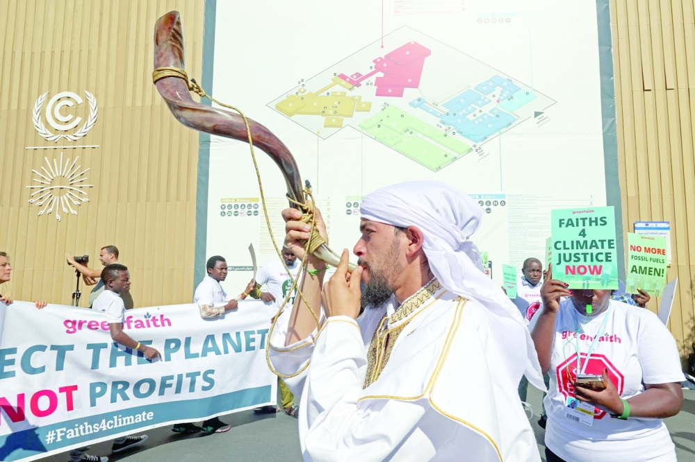 Climate activists stage a protest during the COP27 climate conference in the Red Sea resort of Sharm el-Sheikh on Friday. -- AFP
