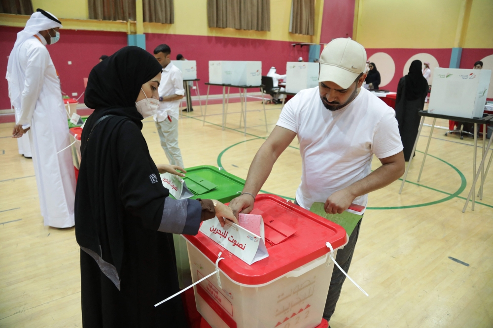 A Bahraini woman casts her ballot at a polling station in the city of Jidhafs, about 3km west of the capital Manama, during parliamentary elections, on Saturday. — AFP 