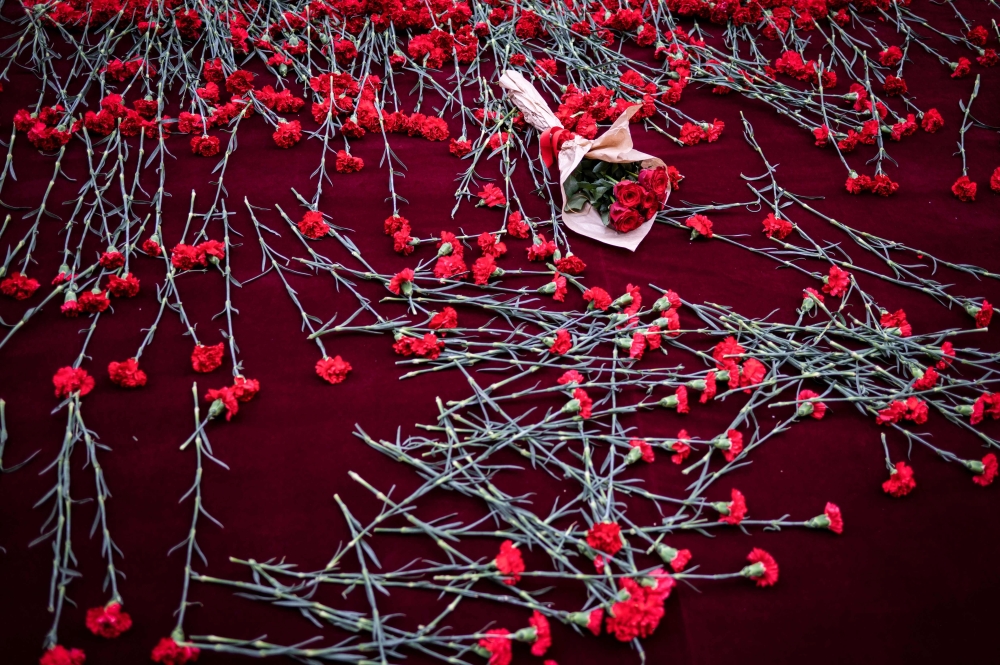 This photograph taken on November 14, 2022, shows flowers layed at the spot of November 13 explosion in the busy shopping street of Istiklal in Istanbul, as people grieve the victims.