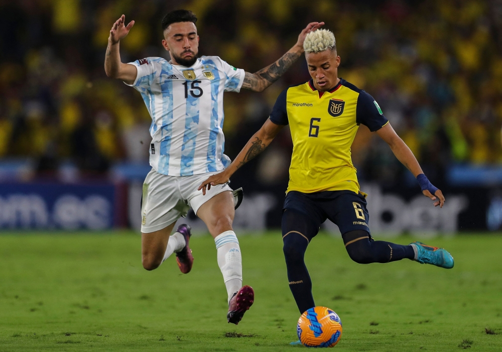 In this file photo taken on March 29, 2022, Argentina's Nicolas Gonzalez (L) and Ecuador's Byron Castillo vie for the ball during their South American qualification 