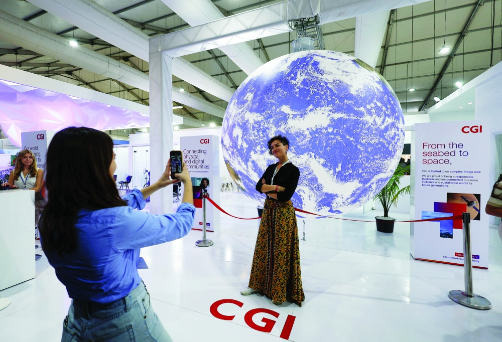 An attendee poses for a photo during the COP27 climate summit in Sharm el Sheikh on Thursday. — Reuters