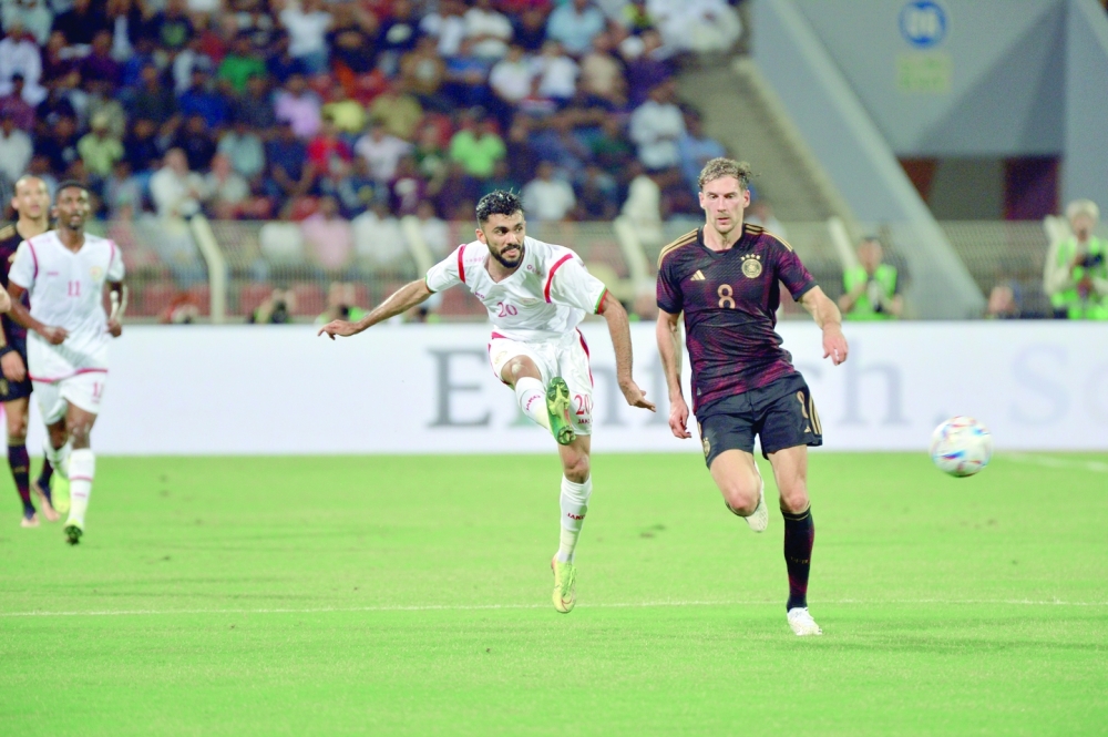 Oman and Germany players fight for the ball. -- AbdulWahid al Hamadani