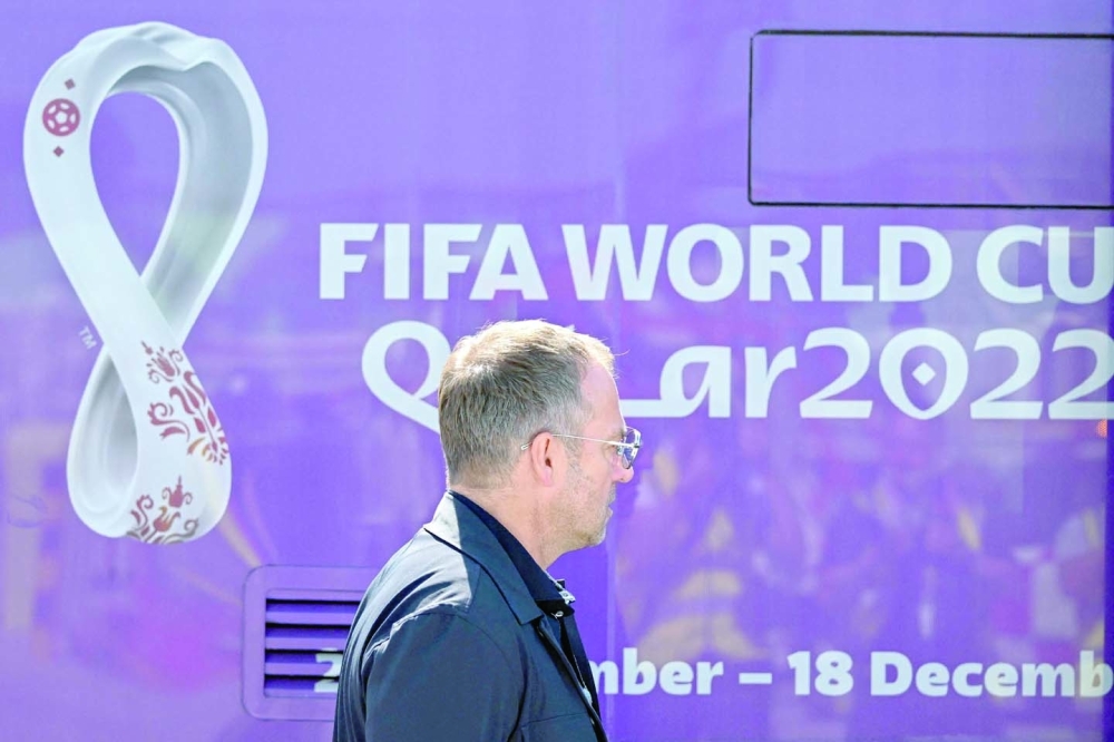 Germany's coach Hans-Dieter Flick makes his way to board a bus after the German team arrived at the airport in Doha, Qatar on November 17, 2022, ahead of the Qatar 2022 World Cup football tournament. (Photo by ANDREJ ISAKOVIC / AFP)

