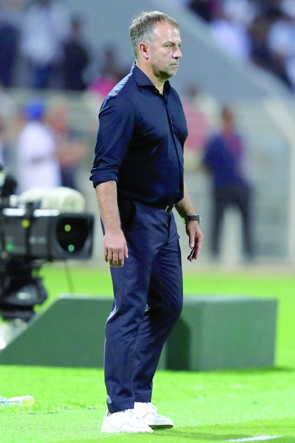 Germany's coach Hans-Dieter Flick watches from the sidelines during a friendly football match between Oman and Germany at the Sultan Qaboos Sports Complex stadium in Muscat on November 16, 2022. (Photo by Haitham AL-SHUKAIRI / AFP)

