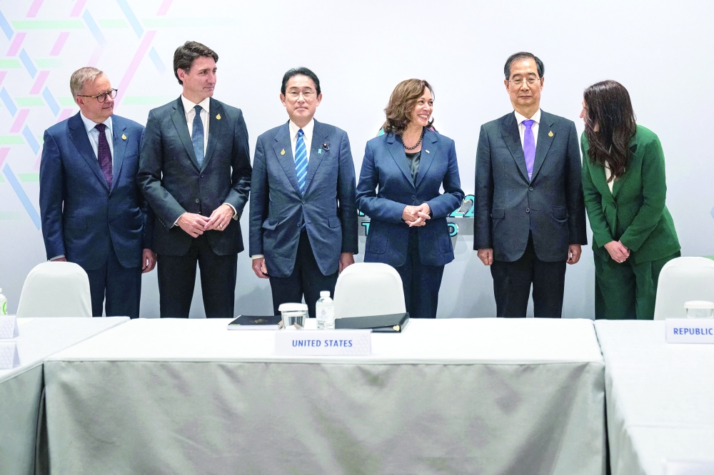 Leaders pose for photo before a meeting in Bangkok. -- AFP